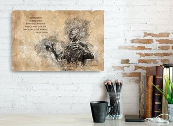 A framed inspirational art piece featuring a black and white image of a statue with an overlay of text quote on a wall.