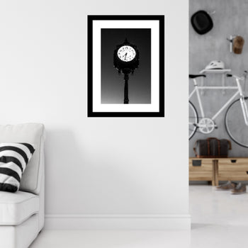 A black and white photo of a rotary club clock mounted on a wall, with a mat and frame that are not included. The image features a silent, classic design.