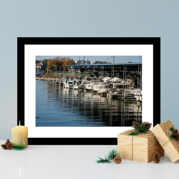 Photograph of Riverwalk Marina in Decatur, Alabama, featuring boats and water reflections along the Tennessee River at sunset mounted on a wall.