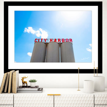 A framed wall art print featuring the City Harbor Tower in Guntersville, Alabama, with a clear blue sky in the background.