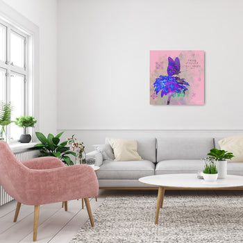 A canvas print featuring a purple butterfly on a pink background, displayed on a wall above a gray sofa and a pink armchair in a living room setting.