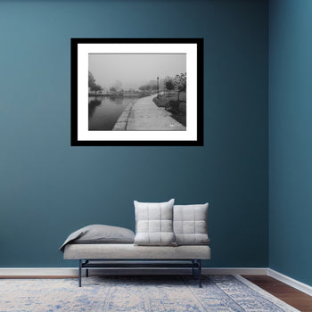 Black and white photo of Big Spring Park Bridge and sidewalk on a foggy morning.