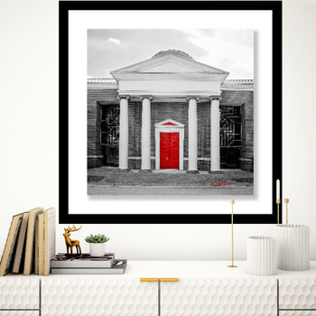 Black and white photo with red door.