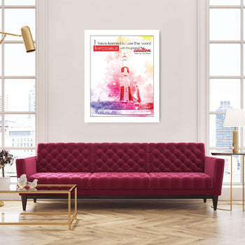 A framed print with a pink and purple abstract design hanging on a wall over a red sofa in a room with large windows.